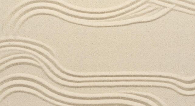 Carefully raked sand surface displays rippled patterns and creates a serene textured background with a neutral color palette and flowing lines. photo