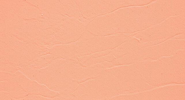 The delicate peach stucco texture exhibits subtle waves and contours, creating a visually appealing surface for backgrounds and designs. photo