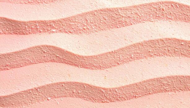 An abstract close-up shows gentle, curving lines in a soft pastel rose color resembling sand dunes or rippling water, offe a soothing texture. photo