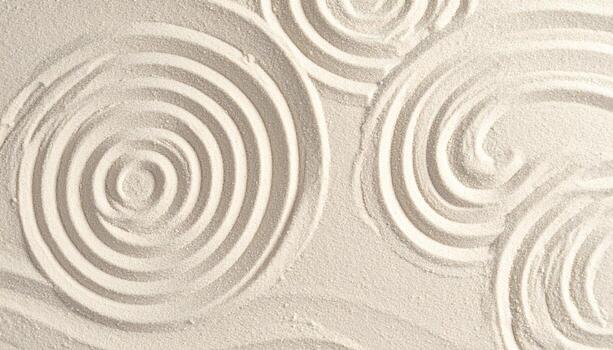 Concentric sand circles create a zen-like pattern, invoking relaxation and a sense of calm on a pristine surface of bright white sand. photo