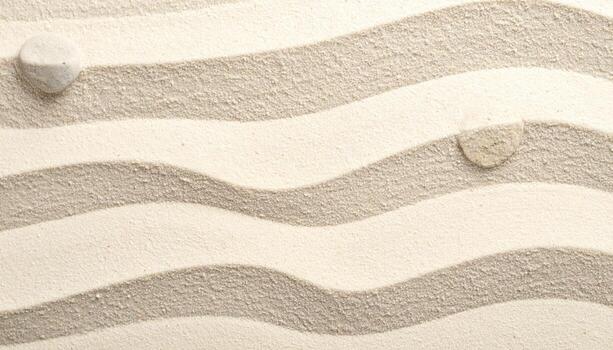 Two small stones rest on raked sand creating a serene and calming zen garden pattern with elegant wavy lines symbolizing peace and harmony. photo