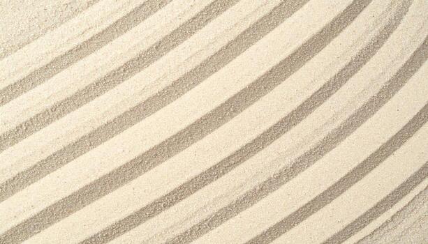 Diagonal patterns and lines are artfully created on the light tan sand surface, exhibiting a minimalist, clean, and textured background. photo