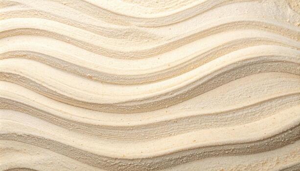 A high angle shot shows sand waves with an intricate pattern of rippling curves in the sunlight on a tranquil, deserted beach area. photo