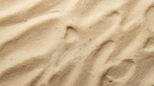 Close up of a textured beige sand background shows natural curves and patterns created by wind and ocean currents at the beach location. photo