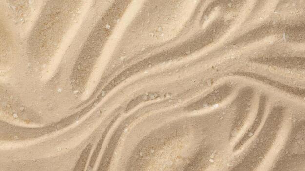 Top down view displays sandy textured surface with subtle ripples and small grainy particles creating natural pattern perfect for background. photo