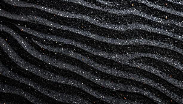 Sparkling glitter decorates the surface of dark textured material with curved wavy lines creating an abstract and interesting pattern effect. photo