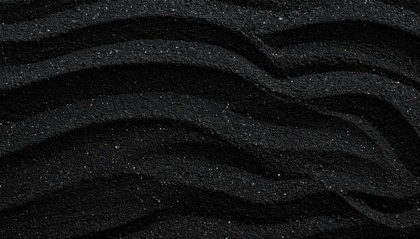 The dark waves form an abstract pattern on the beach creating a mesmerizing background or texture filled with contrasting shadows and light. photo