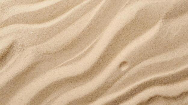 The warm tan sand texture presents smooth flowing curves from the wind leaving wavy patterns creating a beach landscape closeup shot. photo