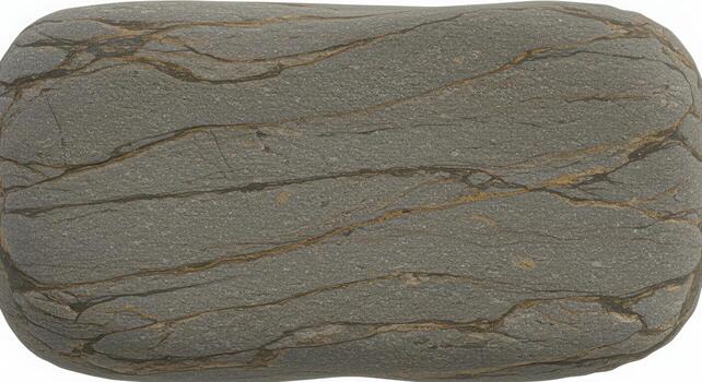 Close up of a smooth grey river stone with intricate gold veins running across its surface creating a natural abstract pattern design element. photo