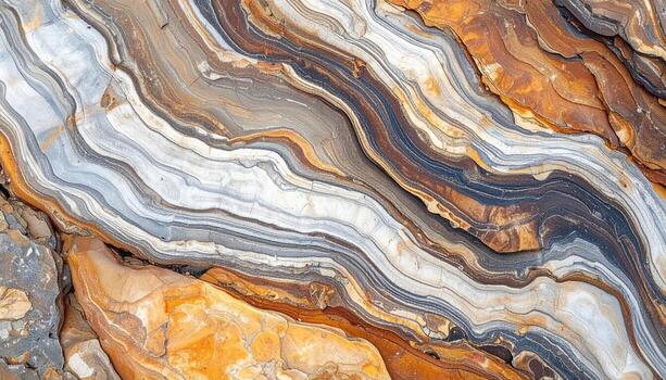 An abstract close up shows flowing multicolored rock strata with mesmerizing organic patterns and earthy natural textures in shades of brown. photo