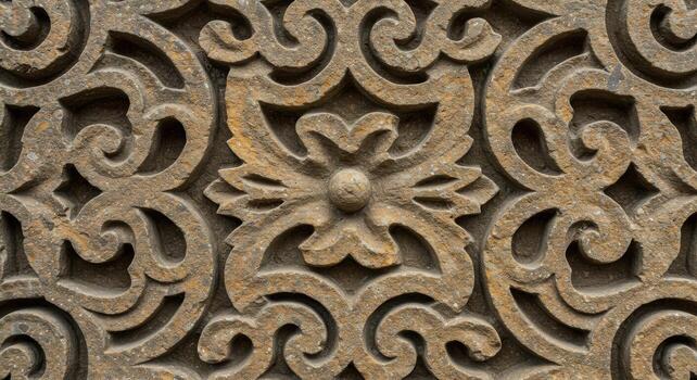 Intricate floral carvings adorn the surface of weathered stone, showcasing a timeless pattern etched in detail and texture for centuries past. photo