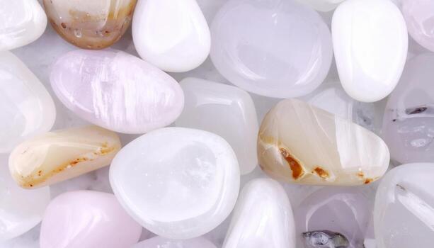 Collection of smooth polished stones featu soft pastel colors and subtle variations in texture creates a calming neutral background element. photo