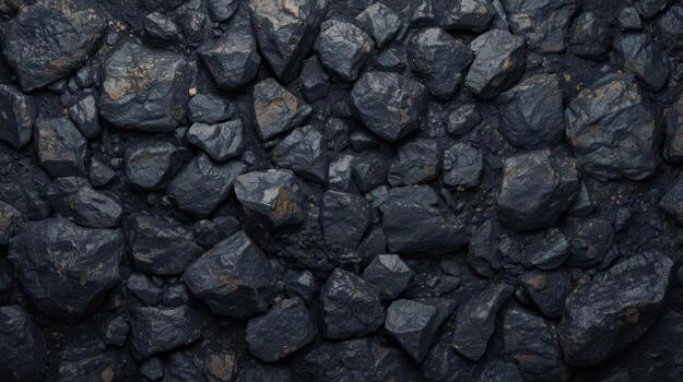 Close up shows natural texture of dark coal rocks scattered across a solid surface in a pile, representing fuel and geological formations. photo