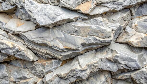 cerca arriba muestra un texturizado apilar de grande gris piedras con visible en capas patrones y natural rock formaciones en un al aire libre ambiente. foto