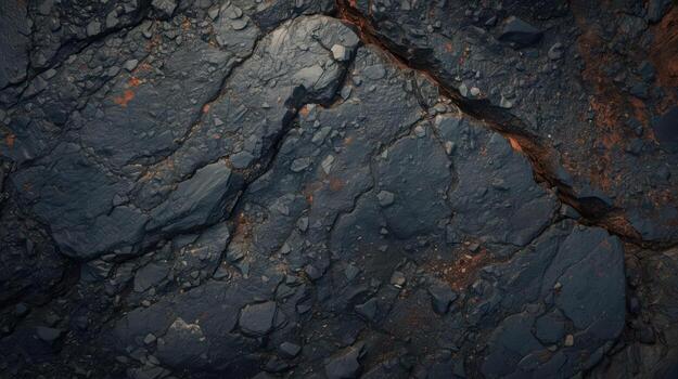 Dark volcanic rock texture featu rough surface with cracks and small stones creating an abstract natural pattern and geological background. photo