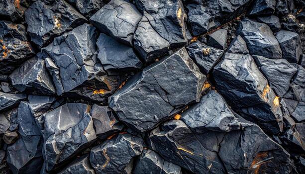 Dark volcanic rock formations create a stark and striking abstract pattern in nature's intricate geological textures on rocky surface landscape. photo
