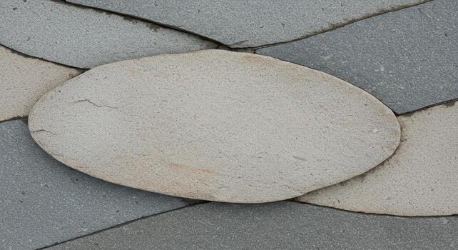 An abstract stone floor showing an oval stone surrounded by grey stones in an overlapping pattern creating a natural textured surface. photo