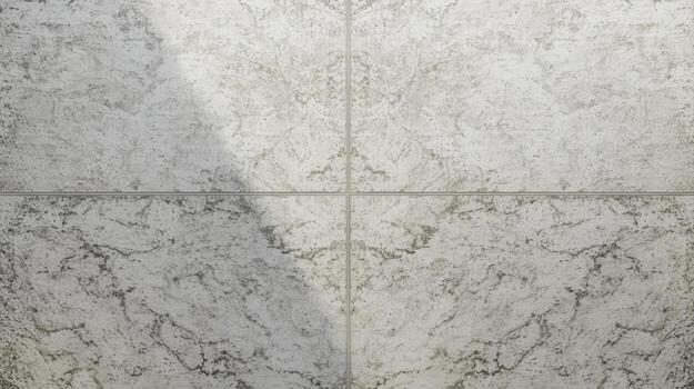 The textured grey stone tiles are laid out in a simple grid pattern to create a clean and modern architectural surface for the floor. photo