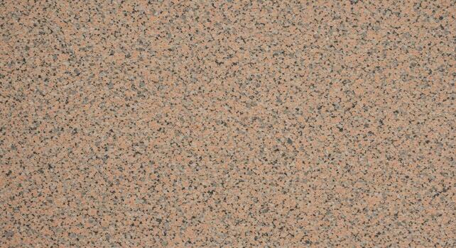 The textured surface reveals a speckled blend of light pink and gray tones creating a subtle granite stone appearance for backgrounds or materials. photo