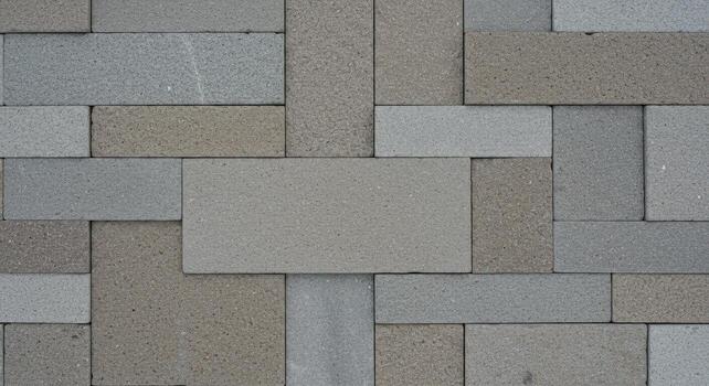 An abstract geometric arrangement of light gray and brown rectangular blocks creates a modern and textured neutral background for design purposes. photo