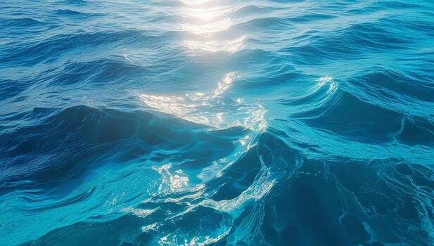Sunlit sea with turquoise waters, captivating ripple patterns and dynamic wave forms photo