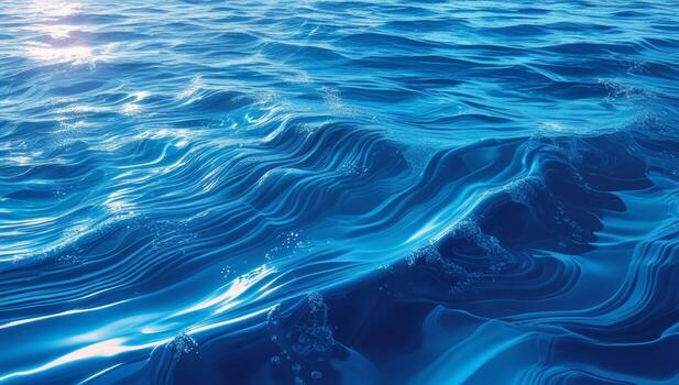 Serene expanse of crystal blue water reflecting sunlight with gentle waves flowing across the surface photo