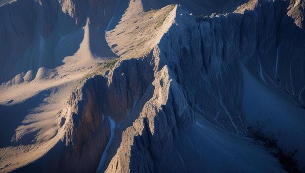 Dramatic mountain range with jagged peaks and contrasting light creating scenic vistas photo