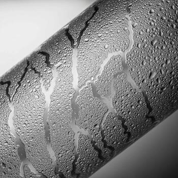 Close up macro view of condensation droplets forming abstract patterns on a textured surface photo