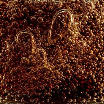 Macro view of tiny bubbles and swirling liquid forms creating an abstract organic texture photo