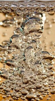 Close up abstract view of shimmering golden liquid with numerous small bubbles rising and distorting the surface photo