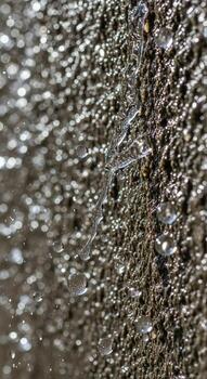 Close up abstract texture of shattered glass with intricate spiderweb cracks and reflective light patterns photo