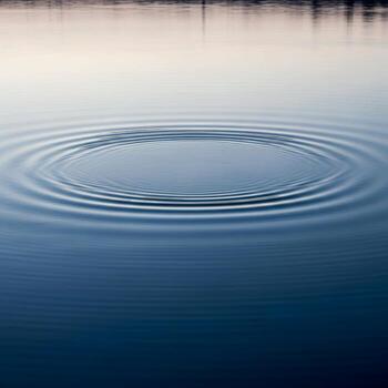 Calm blue water surface with concentric ripples emanating from a central point creating a serene and tranquil visual effect photo