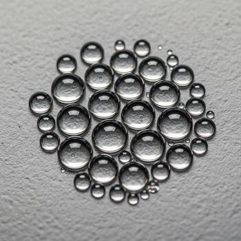 macro fotografía de un racimo de claro agua gotas formando un circular modelo en un texturizado gris superficie foto