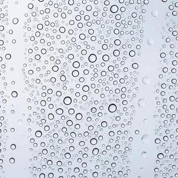 Close up macro view of numerous tiny water droplets on a clear surface creating a textured abstract pattern photo