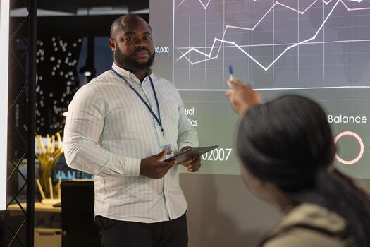 Diverse business associates reviewing performance metrics data within the multinational company. Conducting analytics for general overview, professional development after hours. photo