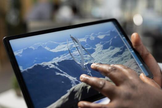 Close up of technician using touchscreen tablet to evaluate next generation wind turbine boosting green energy output. Product designer develops cutting edge vertical axis wind turbine using device photo
