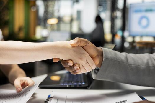 Close up of candidate and manager sharing handshake after successful interview, marking the start of onboarding, career development and employment process. Commitment to new position. photo
