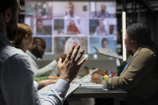 Staff from a multinational company coordinate with global partners via web call for a night strategy session, reviewing proposals and sharing insights in real time collaboration. Project agenda. photo