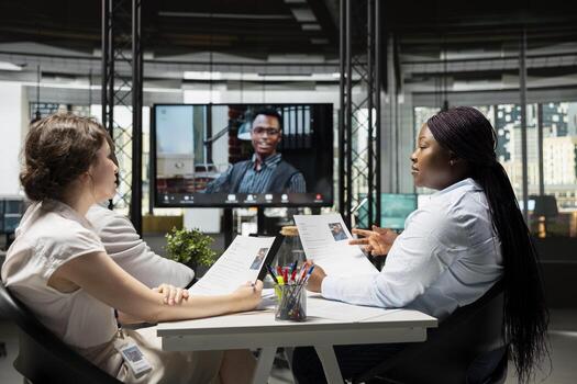 Confident candidate joining online call hiring interview with HR team using high tech office, evaluating the CV and career goals to guarantee potential for the job requirements. photo