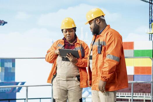 Engineering team inspecting integrity of offshore platform components to avoid downtime. Drilling rig teamworking colleagues use diagnostic tools to detect malfunction in subsea pipelines photo