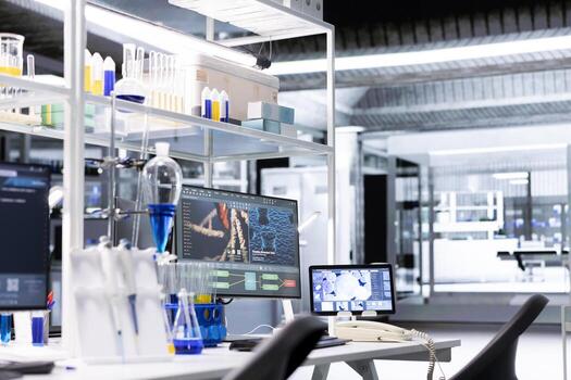 Research facility workstation with monitor and tablet displaying DNA data and molecular analysis interface. Bioinformatics genomics visualization on PC in laboratory environment photo