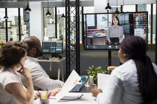Diverse HR staff hosting a virtual meeting to interview a candidate via web conference, discussing the job application and professional background of the person for a potential fit. photo