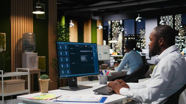 Black worker uses AI chatbot system at desktop for problem solving tasks, futuristic technology highlighting smart algorithms and machine learning. Communication and IT support. photo