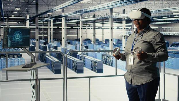Data center IT expert investigates AI configurations using virtual reality, making adjustments for optimal function. Server hub engineer checks artificial intelligence error using VR headset, camera A photo