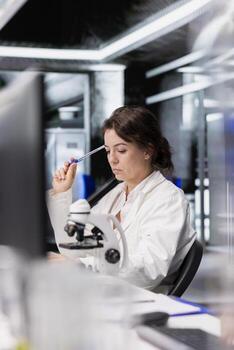 Laboratory scientist brainstorming ideas, using computer to process DNA patient data for clinical research. Research facility specialist doing thinking, interpreting lab genetic analysis diagnostics photo