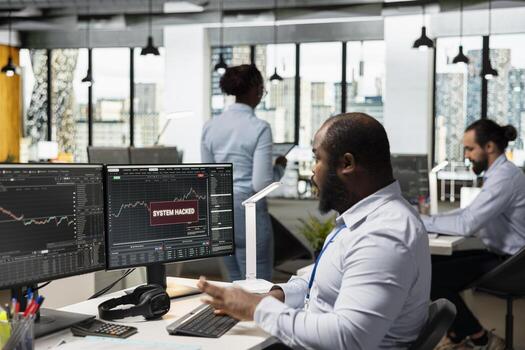 Trader in office receives system hacked warning alert after unauthorized access detected on client trading account. Prop firm worker worried by hacker breaching trading platform account cybersecurity photo