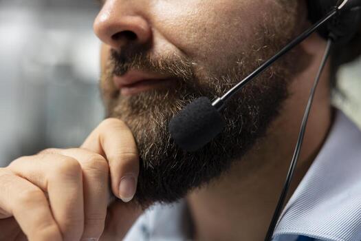 Close up of portfolio manager speaking in headset mic, talking with clients, explaining stock exchange trends. Man chatting with customers, overseeing investments to maximize returns photo