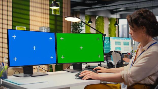 Focused office administrator using data for forecast with a green screen, building a new development strategy to expand the business and boost performance reports. Professional objectives. photo