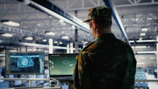 Army expert in data center integrating AI machine learning into radar systems for missile tracking. Military soldier in server farm analyzing aerial movement through neural networks systems, camera B photo