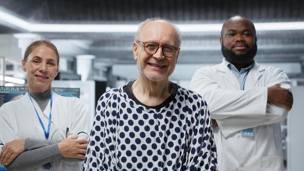 Portrait of smiling old patient and scientists team preparing for RD strategy, working in laboratory for new drug testing and monitoring vitals. Diverse researchers at modern institute. Camera B. photo